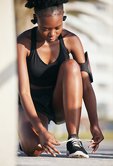 Image showing Black woman, outdoor and tie shoes for workout, training and exercise. Sports, fitness and African athlete tying laces on sneakers to start running, prepare for cardio and jog, health and wellness