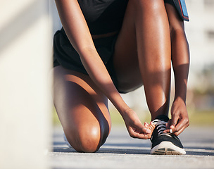 Image showing Outdoor, hands and runner tie shoes to start workout, training or exercise. Sports, fitness and athlete tying laces on sneakers to prepare for cardio, running and jog for health or wellness on ground