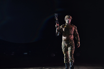 Image showing A professional soldier in full military gear striding through the dark night as he embarks on a perilous military mission