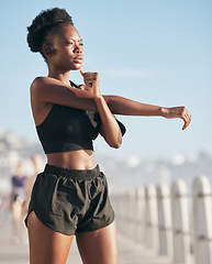 Image showing Fitness, vision and stretching with a black woman runner outdoor on a blurred background for cardio or endurance training. Exercise, sports and music with a young athlete getting ready for a workout