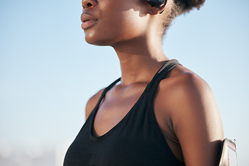 Image showing Fitness, blue sky and black woman on outdoor workout, goals and streaming music with phone. Exercise, internet and girl with mobile app for running schedule, breathing and health mindset in Africa.