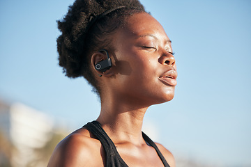 Image showing Black woman, runner and thinking with headphones in city, outdoor or tired with fitness, health or music. African girl, running or listen with eyes closed, streaming or mindset with fatigue in summer