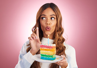 Image showing Surprise, cake and taste with woman in studio for birthday, party and event. Rainbow, dessert and celebration with young female isolated on pink background for food, happiness and festive treat