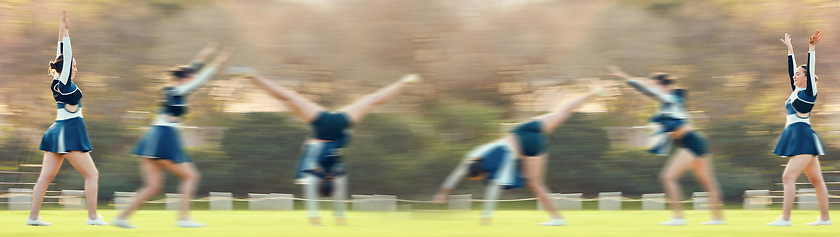 Image showing Sports, athlete and woman doing a cheerleading trick on the field while performing a routine. Fitness, blur motion and female cheerleader doing a cart wheel with skill while practicing or training.