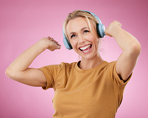 Image showing Music, dance and freedom with a woman in studio on a pink background for crazy fun or cheerful positivity. Party, energy and radio with a person streaming audio while dancing on a pastel color wall