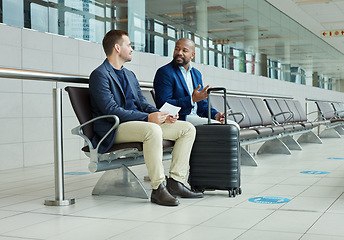 Image showing Ticket, airport and business partner or people talking of flight schedule, travel news or schedule update together. Conversation, waiting room and international or professional person with suitcase