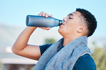 Image showing Drinking water, fitness and tired man training, exercise or outdoor workout nutrition, health and wellness. Liquid bottle for diet, sports goals and cardio of runner, athlete or person on blue sky