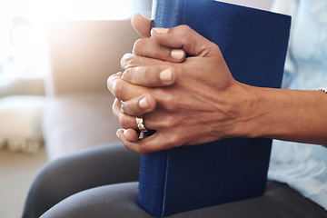 Image showing Book, prayer and hands of old woman in living room for religion, bible and Christian faith. Spiritual, God and worship with senior lady praying with holy text at home for wellness, believe and goal