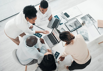 Image showing Business people, laptop and meeting in planning above for web design, strategy or brainstorming at the office. Top view of group designers working on computer for team project plan or idea on table