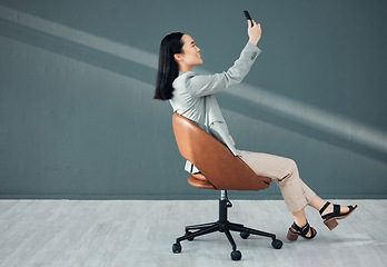 Image showing Selfie, video call and woman with a phone for connection, signal and communication at work. Conversation, corporate and Asian employee reading an email, message or chat on a mobile app in an office