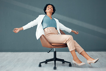 Image showing Chair, fun and carefree with a business black woman sliding on the floor of her office feeling stress free. Freedom, relax and success with a female employee riding a seat alone in the workplace