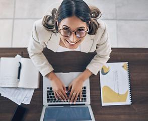 Image showing Top view, portrait or business woman on laptop in company finance management, investment strategy or global financial growth. Smile, happy or worker typing on technology for budget planning or ideas