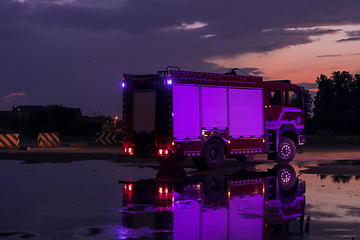 Image showing Fire truck emergency vehicle. Firefighting apparatus and water to save lives, suppress wildfire, extinguish building fires and assist vehicle collisions or traffic car crash accidents.