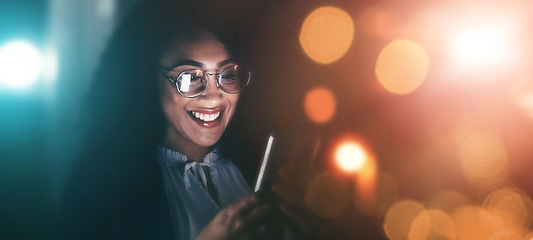 Image showing Businesswoman, phone and smile in communication at night for texting, chatting or networking on dark background. Happy female employee holding smartphone working late for online planning strategy