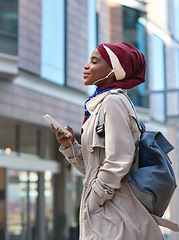 Image showing Relax, music and phone with black woman in city for happy and calm, streaming and social media. Technology, internet and radio with muslim girl or student listening to earphones for online podcast
