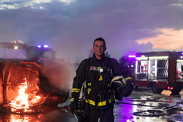 Image showing Portrait of a heroic fireman in a protective suit. Firefighter in fire fighting operation.