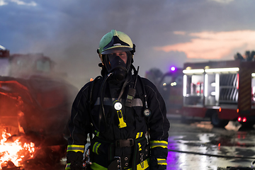 Image showing Portrait of a heroic fireman in a protective suit. Firefighter in fire fighting operation.