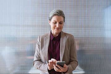 Image showing Phone, business woman and typing in office, social media or internet browsing online. Technology, cellphone and happy senior female ceo with mobile smartphone for networking, texting or web scrolling