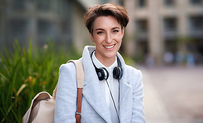Image showing Business woman, smile in portrait outdoor, young creative in city with success, happy and travel to work. Mockup, headshot and professional with headphones, content creator or web designer in Boston