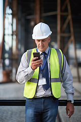 Image showing Construction, engineer and man with a phone outdoor for building project management contact. Contractor person with helmet and smartphone for civil engineering, safety and development communication