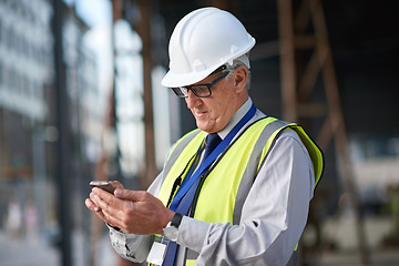 Image showing Construction, engineer and man with phone for communication for building project management. Senior contractor person typing on smartphone for civil engineering contact, safety or development at site