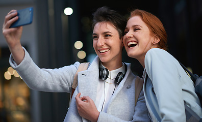 Image showing Women, smile and business people take selfie in city for happy memory in street at night. Photographer, profile picture and friends or coworkers laughing at joke and taking pictures for social media.