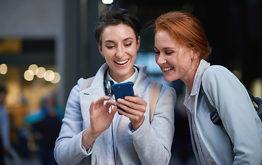 Image showing Friends, laughing and business people with phone in city for social media in street at night. Technology, smartphone and happy women or coworkers laugh at funny meme, comic joke and internet browsing