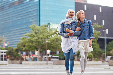 Image showing Walking, bonding and friends in the city street on the weekend for quality time and fun. Diversity, laughing and women crossing the road on an urban walk together during travel and exploration