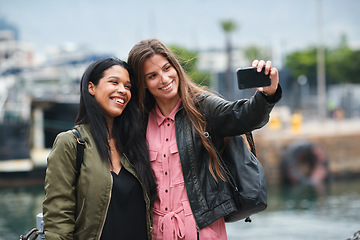 Image showing Selfie, travel and diversity with tourist friends taking a picture outdoor together in a foreign city abroad. Happy, smile or bonding with a female and friend posing for a photograph overseas