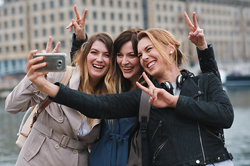 Image showing Corporate women, selfie and peace in city with friends, profile picture and happy on travel. Young executive group, smartphone or solidarity for social media, blog and post by river in London metro