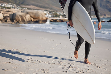 Image showing Surfing, man and walking on sand, sea and ocean for summer vacation, freedom or wellness. Legs of surfer guy, board and walk on beach of relaxing holiday, travel adventure or water sports in sunshine