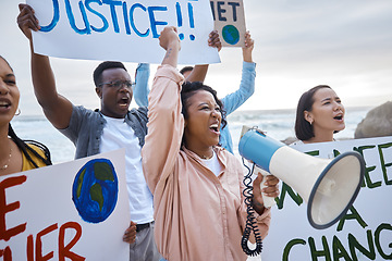 Image showing Climate change sign, megaphone and woman protest with crowd at beach protesting for environment and global warming. Save the earth, group activism and people shouting on bullhorn to stop pollution.