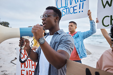 Image showing Protest, climate change and megaphone with black man at the beach for environment, earth day and action. Global warming, community and pollution with activist for social justice, support and freedom