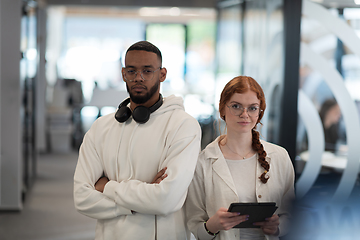 Image showing In a modern office African American young businessman and his businesswoman colleague, with her striking orange hair, engage in collaborative problem-solving sessions