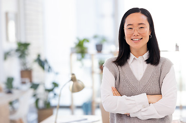 Image showing Asian woman, portrait and arms crossed at startup with smile, leadership and focus for seo management. Young executive, social media manager and modern office for goals, vision and confident in Tokyo