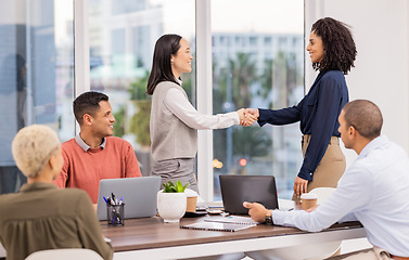 Image showing B2b, black woman or manager shaking hands in meeting or startup project partnership or business deal. Teamwork, handshake or happy Asian worker talking or speaking of our vision or hiring agreement