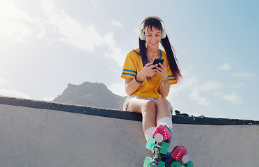 Image showing Relax, phone and music with woman and rollerblades for skating, streaming and social media app. Technology, headphones and sports with girl in skate park for internet, mobile radio and fitness