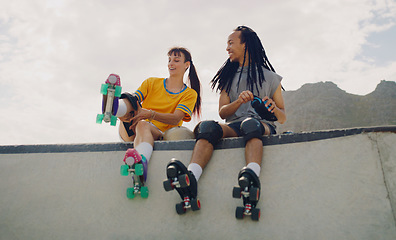 Image showing Rollerskate, skatepark and fun with a couple of friends sitting outdoor on a ramp for recreation together. Fitness, diversity or sports with a man and woman bonding outside for an active hobby