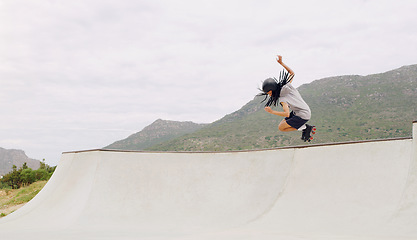 Image showing Sports, roller skates and jump with black man in skate park for fitness, exercise and skating hobby mockup. Summer, wellness and action with skater in outdoors for training, cardio and stunt