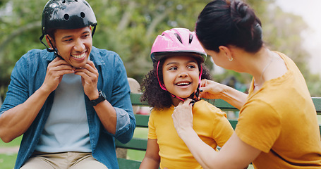 Image showing Parents, park bench and helmet with child, help and safety for skating, rollerskate or bike. Interracial parents, mom and dad with helping hand, teaching and kid for bonding, learning and exercise