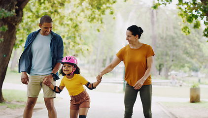 Image showing Parents, park and holding hands to rollerskate with girl child with care, learning and support. Interracial family, black man and woman with kid, smile and helping hand for skating on outdoor holiday