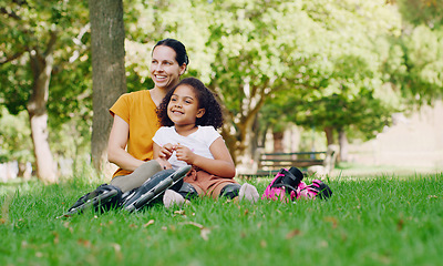 Image showing Family, mother and kid in park with rollerblading outdoor, relax on grass and fun in nature with happy people. Woman, girl and taking a break, sports and quality time together with love and care