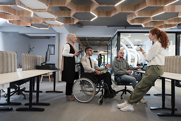 Image showing Young group of business people brainstorming together in a startup space, discussing business projects, investments, and solving challenges.