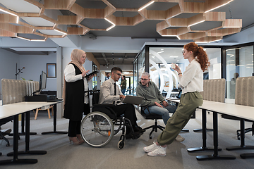 Image showing Young group of business people brainstorming together in a startup space, discussing business projects, investments, and solving challenges.