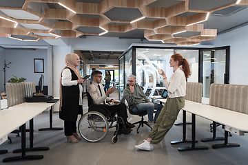 Image showing Young group of business people brainstorming together in a startup space, discussing business projects, investments, and solving challenges.