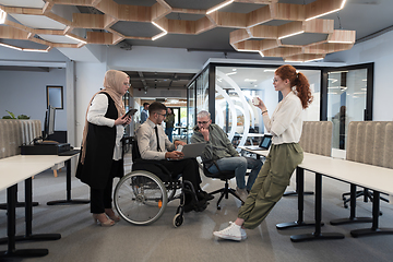 Image showing Young group of business people brainstorming together in a startup space, discussing business projects, investments, and solving challenges.