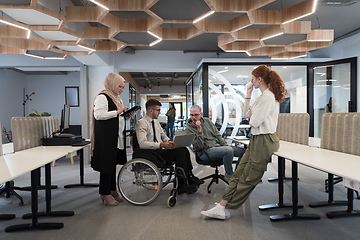 Image showing Young group of business people brainstorming together in a startup space, discussing business projects, investments, and solving challenges.