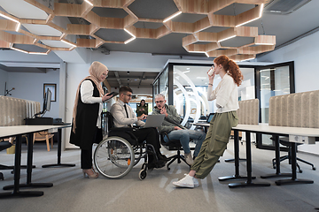 Image showing Young group of business people brainstorming together in a startup space, discussing business projects, investments, and solving challenges.