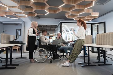 Image showing Young group of business people brainstorming together in a startup space, discussing business projects, investments, and solving challenges.