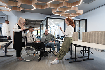 Image showing Young group of business people brainstorming together in a startup space, discussing business projects, investments, and solving challenges.